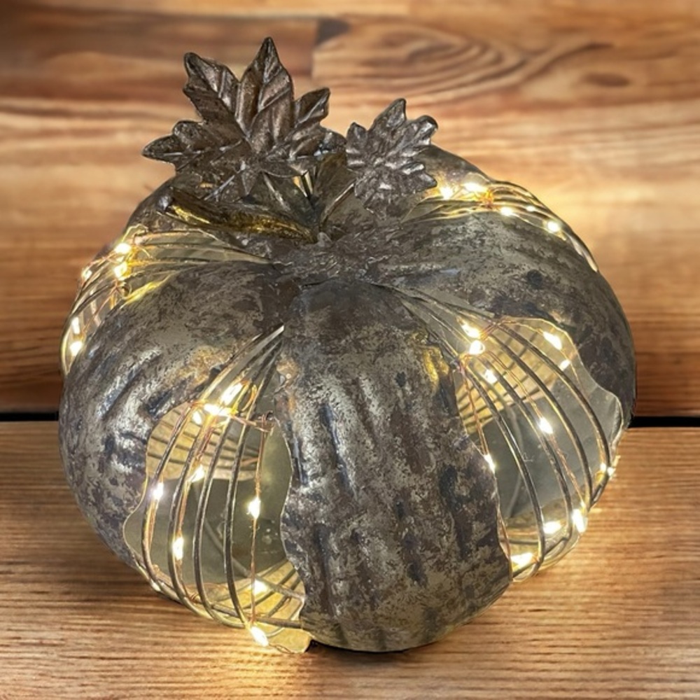 Metal pumpkin with warm twinkling lights in gold / bronze color
